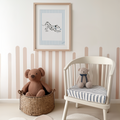 a teddy bear in a basket next to a chair