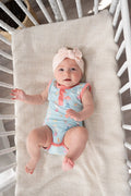 a baby lying in a crib