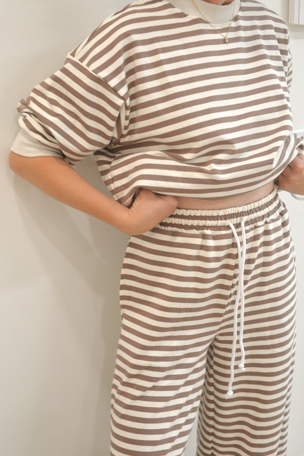 a person wearing a striped shirt and pants