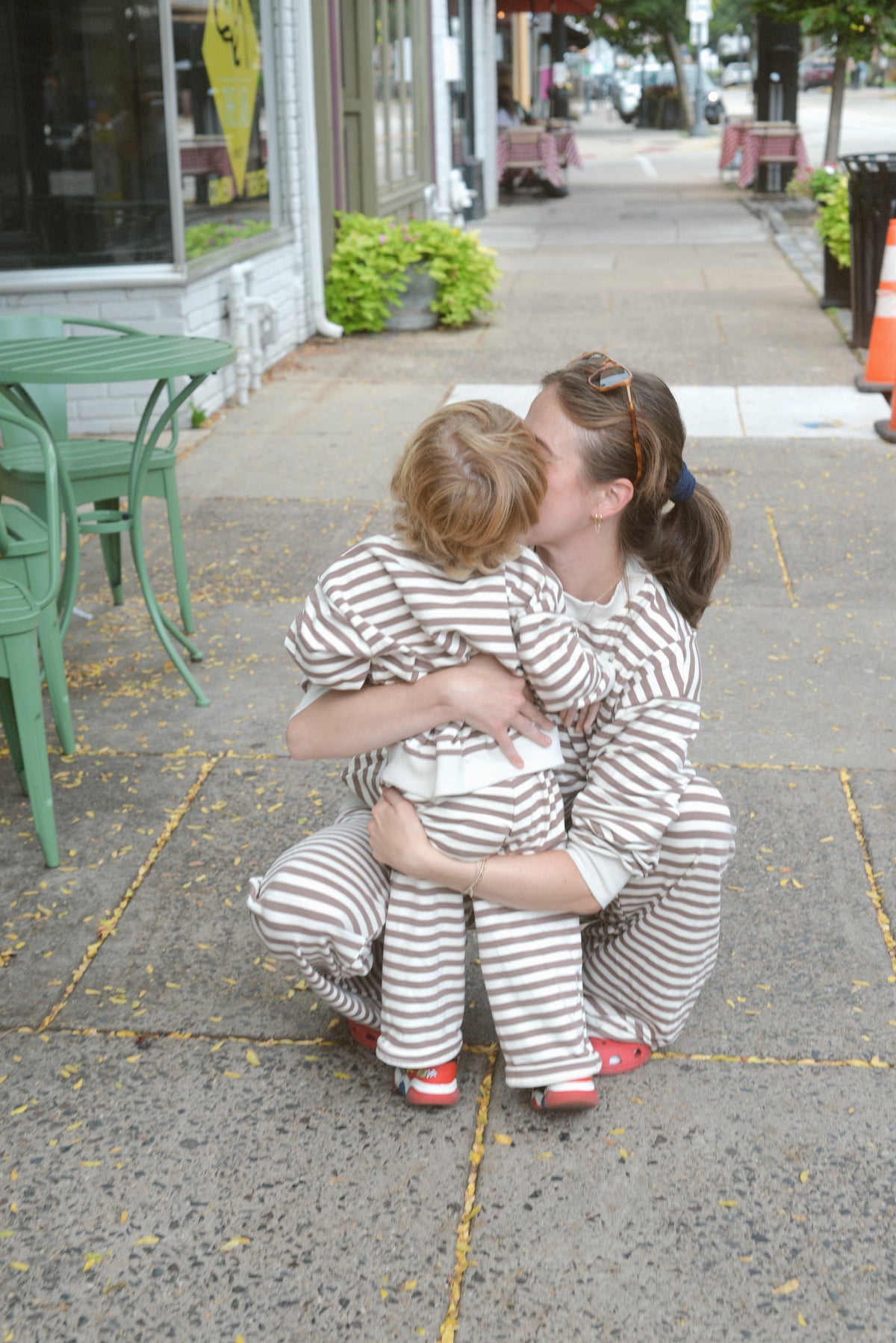 a woman kissing a child