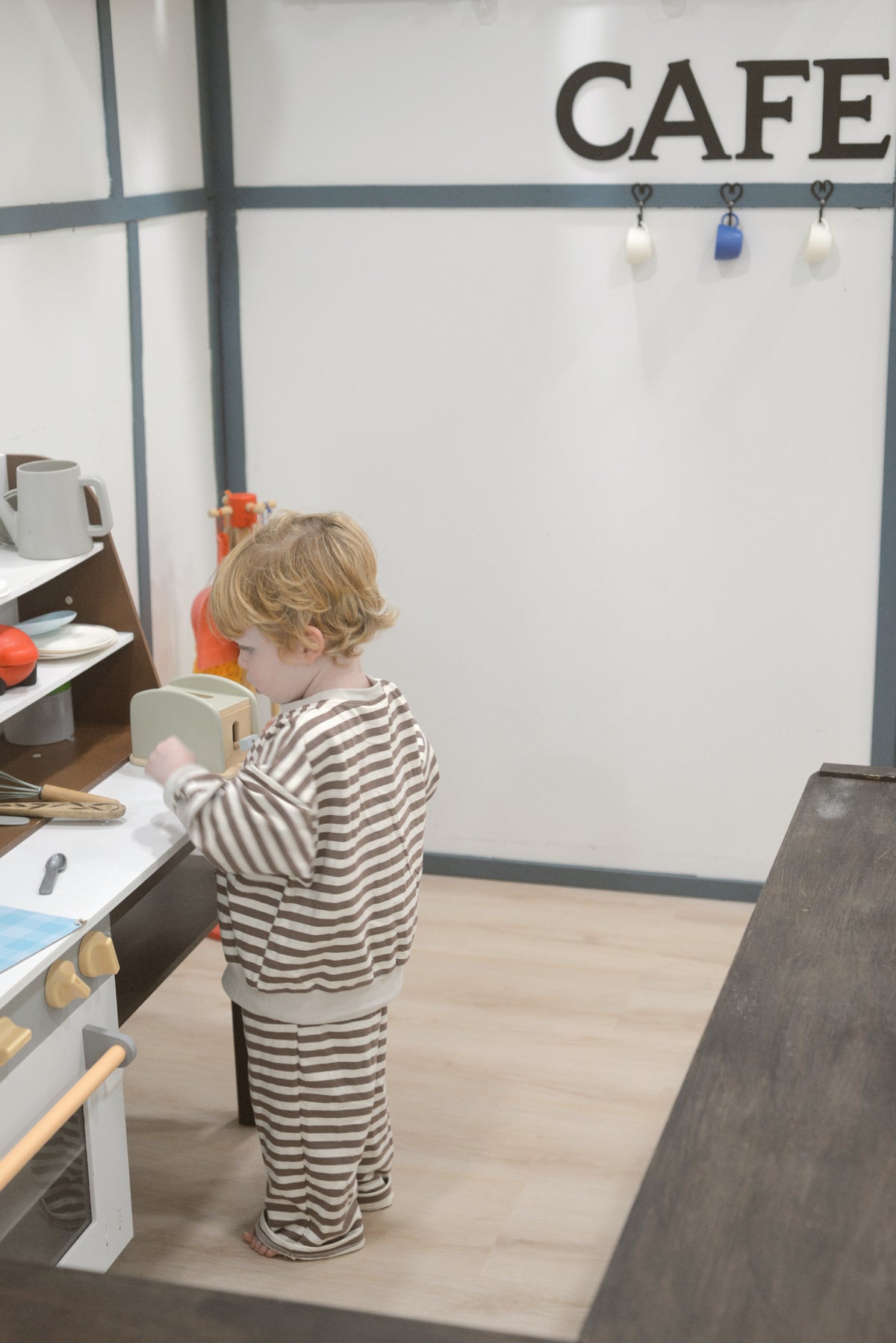 a child standing in a kitchen